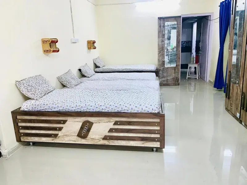 Spacious 3 Sharing Female PG Room with Clean Tiled Flooring in Navrangpura
