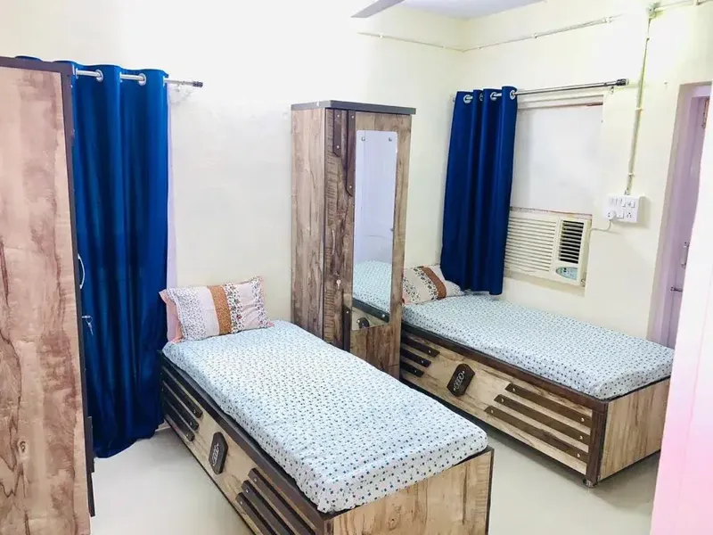 Premium AC Girls PG Room with Comfortable Wooden Box Beds in Ahmedabad