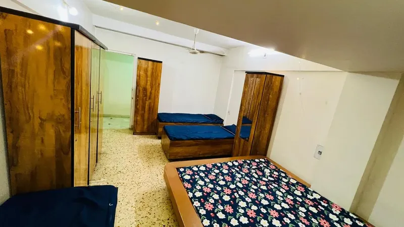 Comfortable Girls PG Bedroom with Wooden Mirror Wardrobes in Ahmedabad