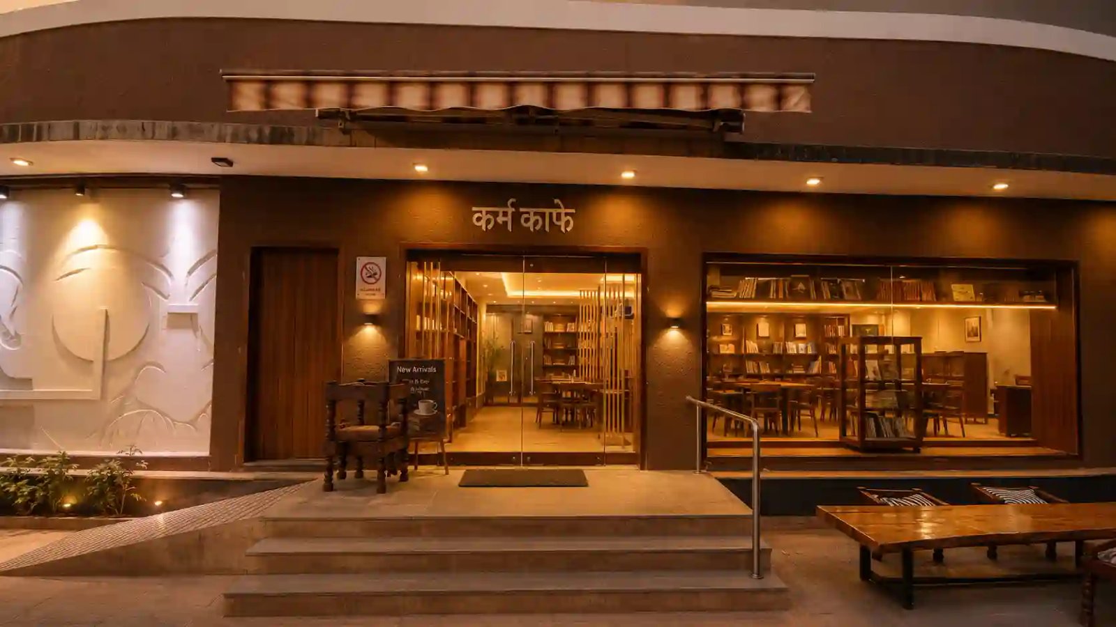 Serene entrance and library bookshelf seating of Karma Cafe Navrangpura Ahmedabad